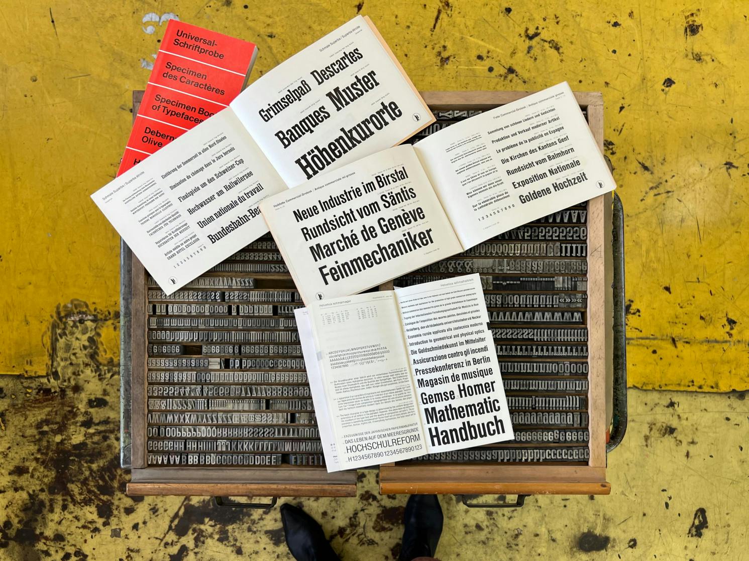Type cases with physical sets of Commercial Grotesk and Superba with printed specimen books of Superba, Commercial Grotesk and Helvetica Schmalhalbfett